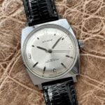 Sandoz plateado New Old Stock, a cuerda.